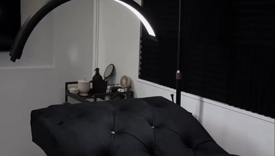 Luxurious treatment room at Ré-luxe Beauty, Mitcham, England, GB, with plush black massage bed.