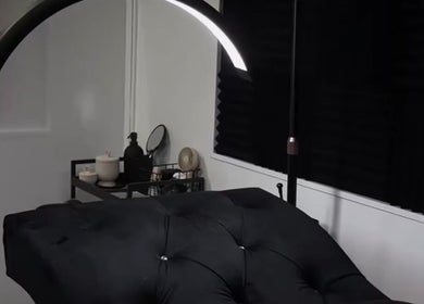 Luxurious treatment room at Ré-luxe Beauty, Mitcham, England, GB, with plush black massage bed.