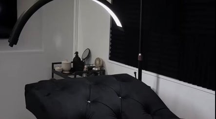 Luxurious treatment room at Ré-luxe Beauty, Mitcham, England, GB, with plush black massage bed.