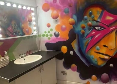 Vibrant wall art and vanity at Lunar Lines, Newhaven, England, GB offering a colorful beauty experience.
