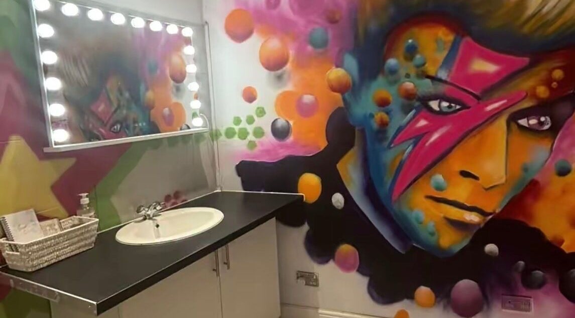 Vibrant wall art and vanity at Lunar Lines, Newhaven, England, GB offering a colorful beauty experience.
