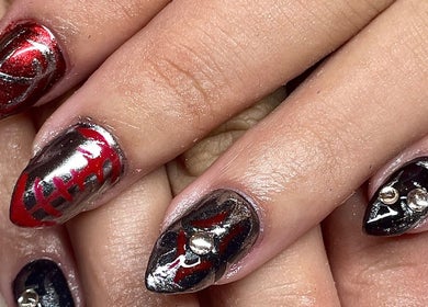 Intricate black and red nail art at Studio Kay at Gloss and Glow, Il-Mosta, MT. Elegant and bold design.