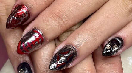 Intricate black and red nail art at Studio Kay at Gloss and Glow, Il-Mosta, MT. Elegant and bold design.
