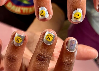 Colorful smiley face nail art at Studio Kay at Gloss and Glow, Il-Mosta, MT, showcasing creative creativity.