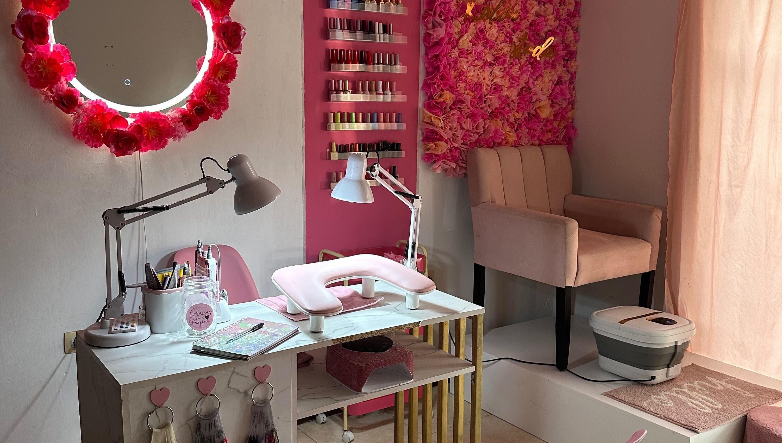 Nail station with pink decor and floral wall at Kalon Studio, Santiago, Santiago, MX.