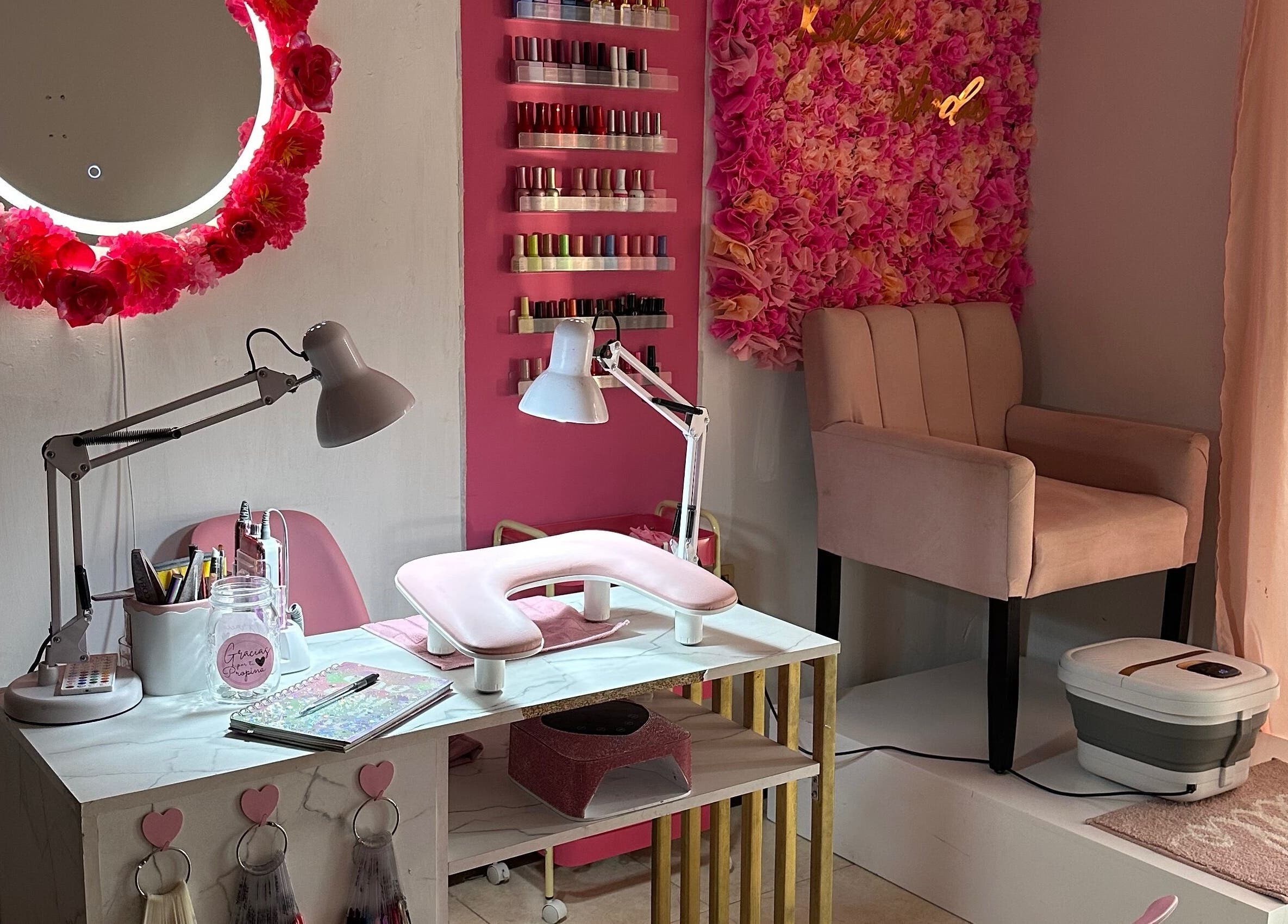 Nail station with pink decor and floral wall at Kalon Studio, Santiago, Santiago, MX.