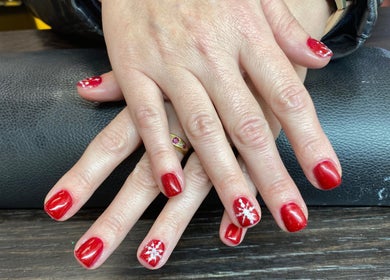 Elegant red manicure with snowflake design at Arch Design Beauty, Tamworth, England, GB.
