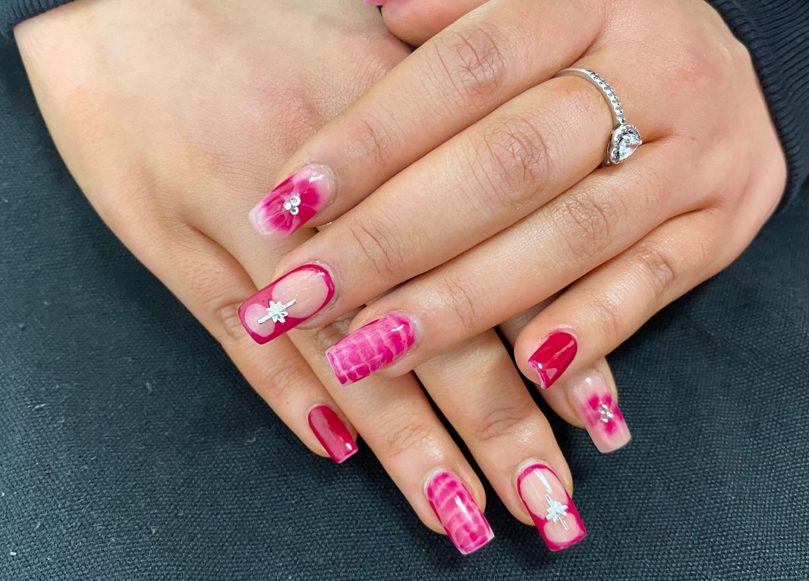 Stylish pink floral gel nails at Arch Design Beauty in Tamworth, England, GB. Perfect for a chic look.