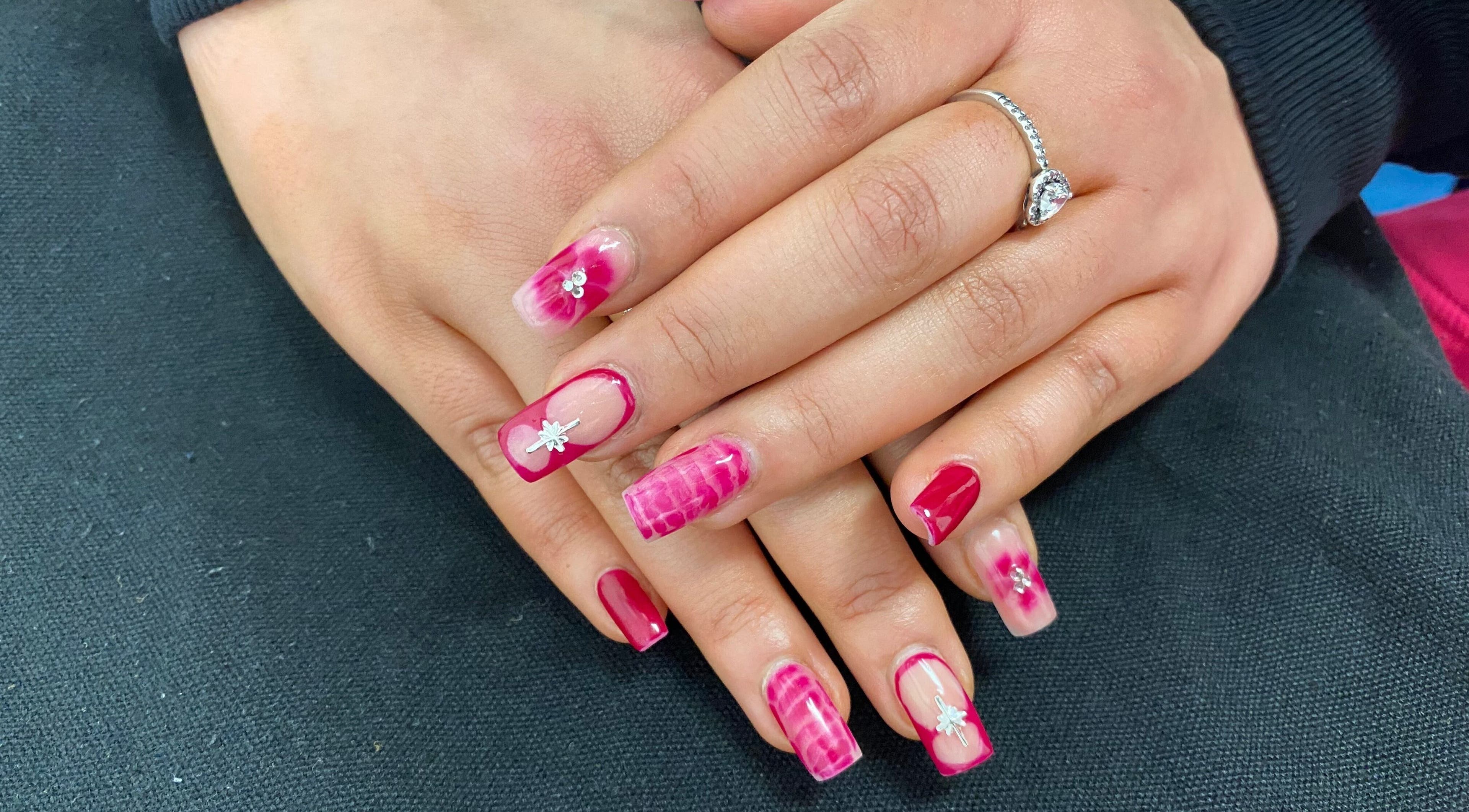 Stylish pink floral gel nails at Arch Design Beauty in Tamworth, England, GB. Perfect for a chic look.