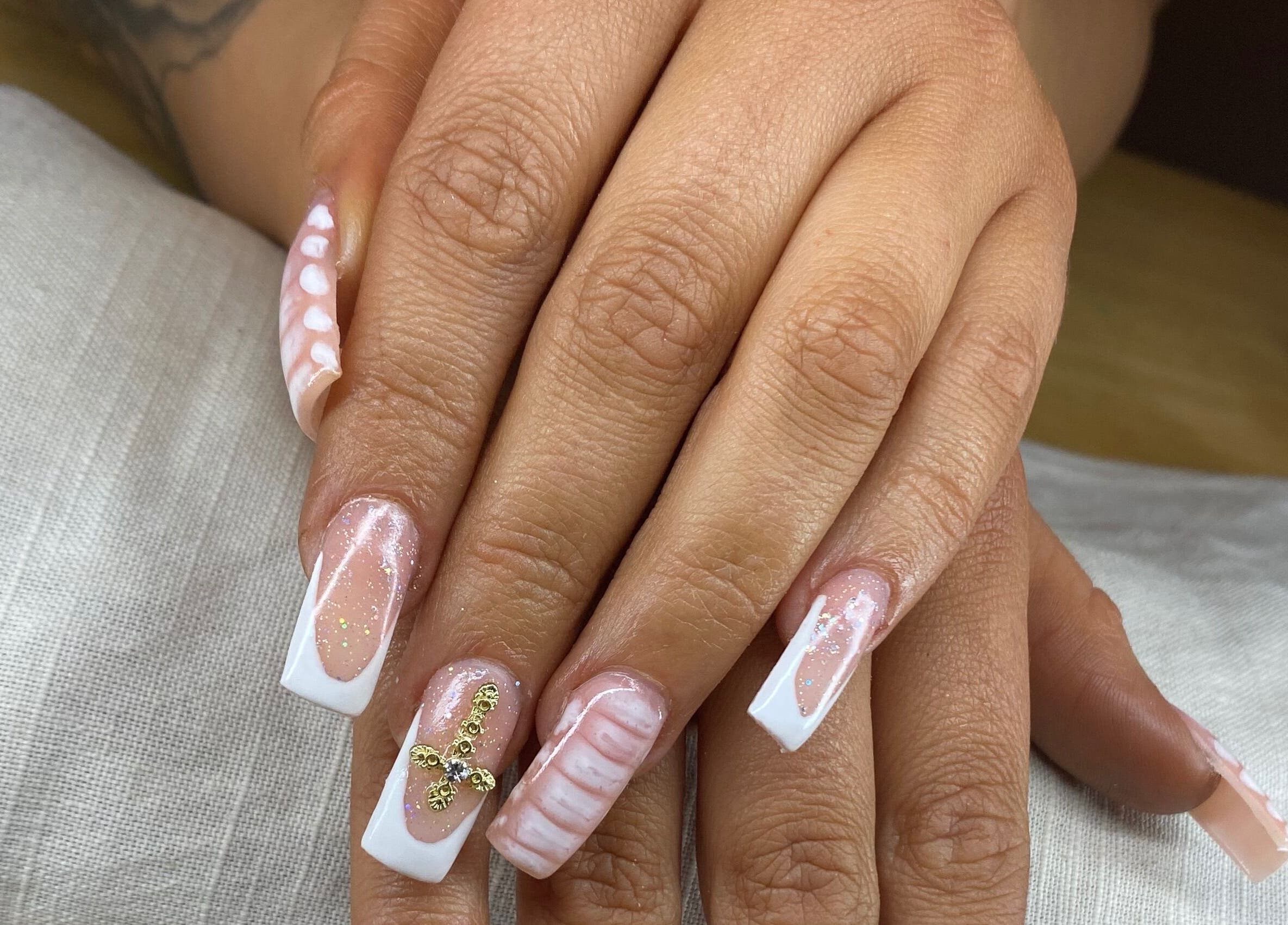 Elegant nail art featuring white and gold designs at Arch Design Beauty, Tamworth, England, GB.