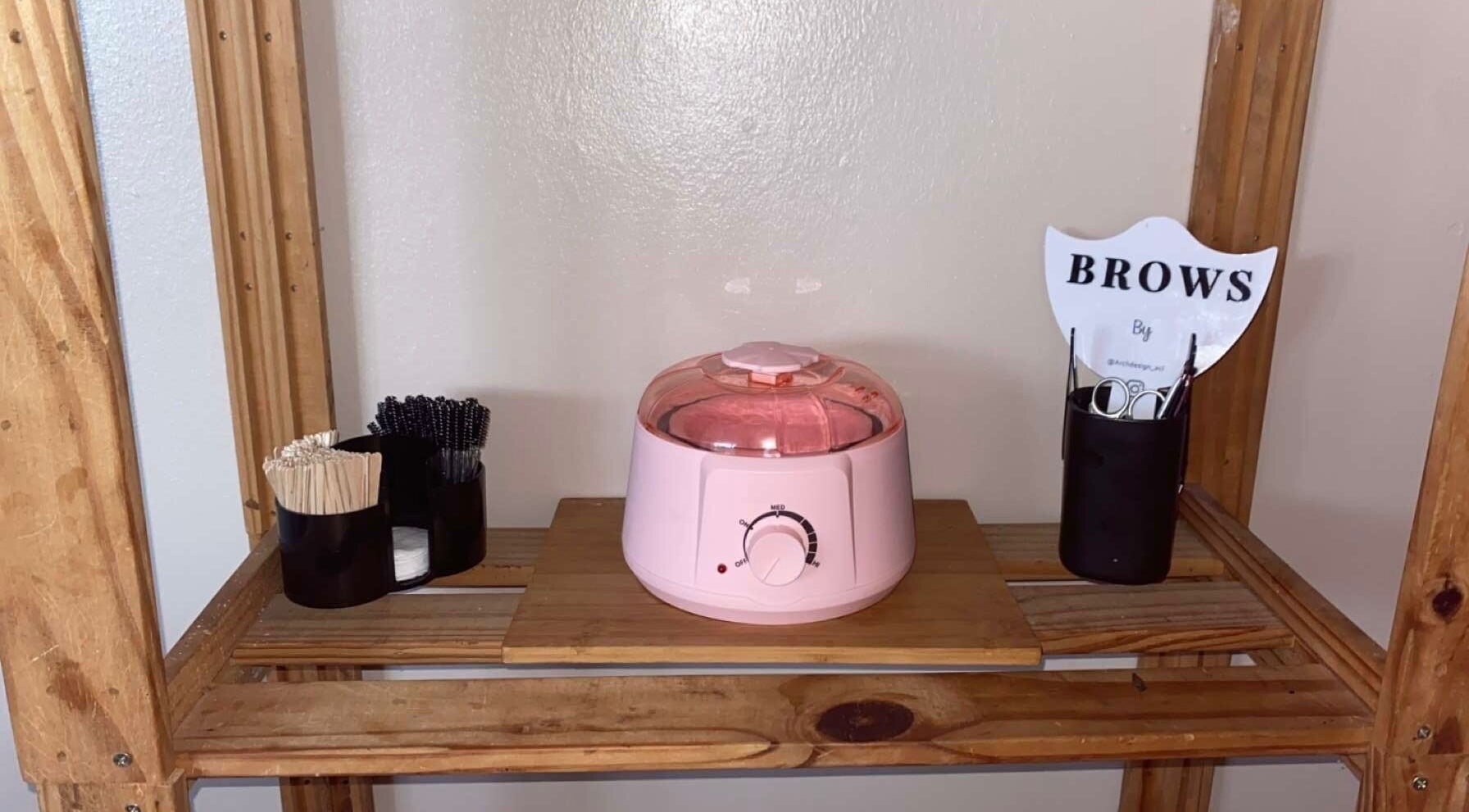 Brow grooming essentials at Arch Design Beauty, Tamworth, England, GB displayed on wooden shelves.