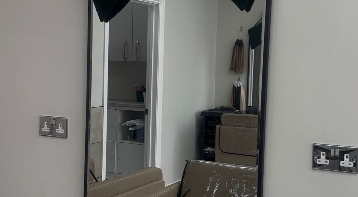 Mirror view of FreyjaMaiHair salon interior in Derby, England, GB with stylish decor.