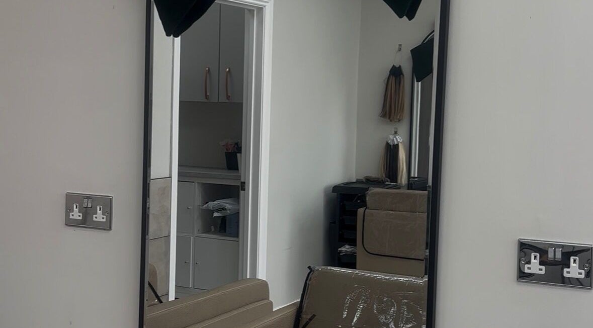 Mirror view of FreyjaMaiHair salon interior in Derby, England, GB with stylish decor.