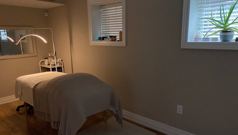 Peaceful treatment room at The Glowing Angel in Toronto, Ontario, CA with ambient lighting and massage table.