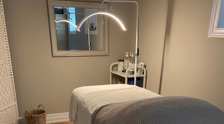 Calm massage room at The Glowing Angel in Toronto, Ontario, CA featuring a cozy treatment bed and ambient lighting.