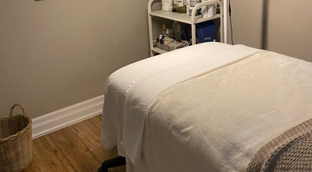 Peaceful treatment room at The Glowing Angel, Toronto, Ontario, CA, featuring a cozy spa bed and products.