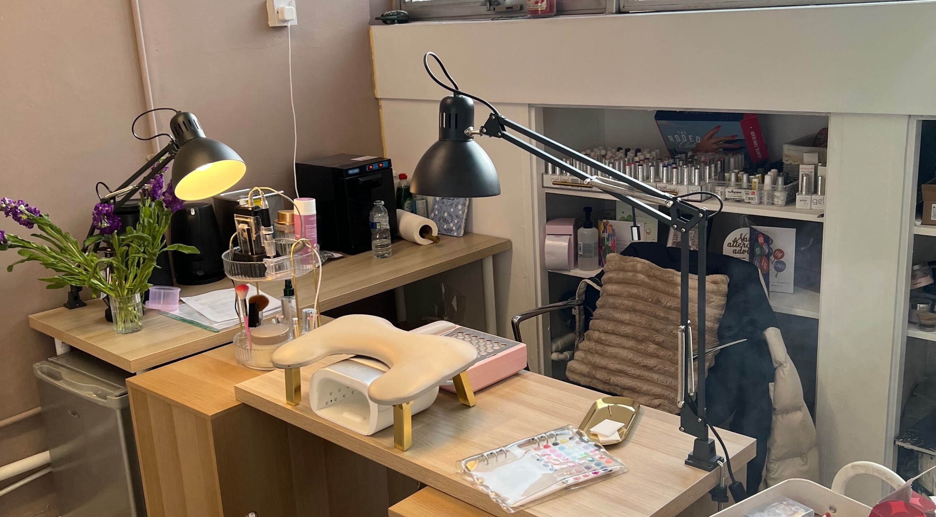 Chic manicure station at The wee Nail Room, Perth, Scotland, GB with tools, lamps, and decor.