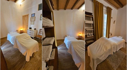 Sala de tratamiento acogedora en Donde los Yayos de Barcelona, Barcelona, Catalunya, ES con camilla y decoración cálida.