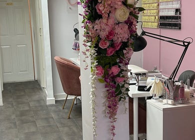 Elegant floral decor at Lashandblowbarx, Widnes, England, GB, with pink hues and beauty workspace ambiance.