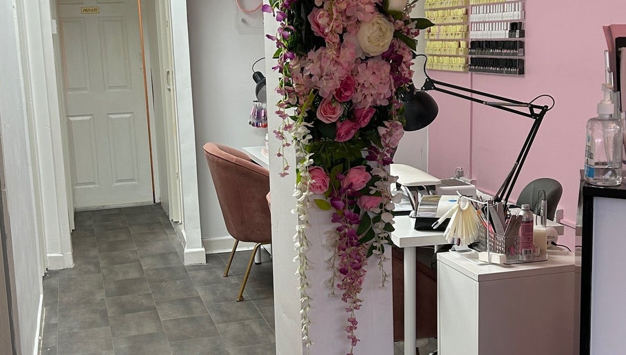 Lush floral decor in beauty station at Lashandblowbarx, Widnes, England, GB. Manicure tools and pink chairs seen.