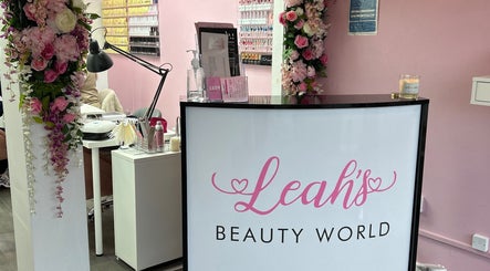 Reception area at Lashandblowbarx, Widnes, England, GB, with floral decor and nail products display.