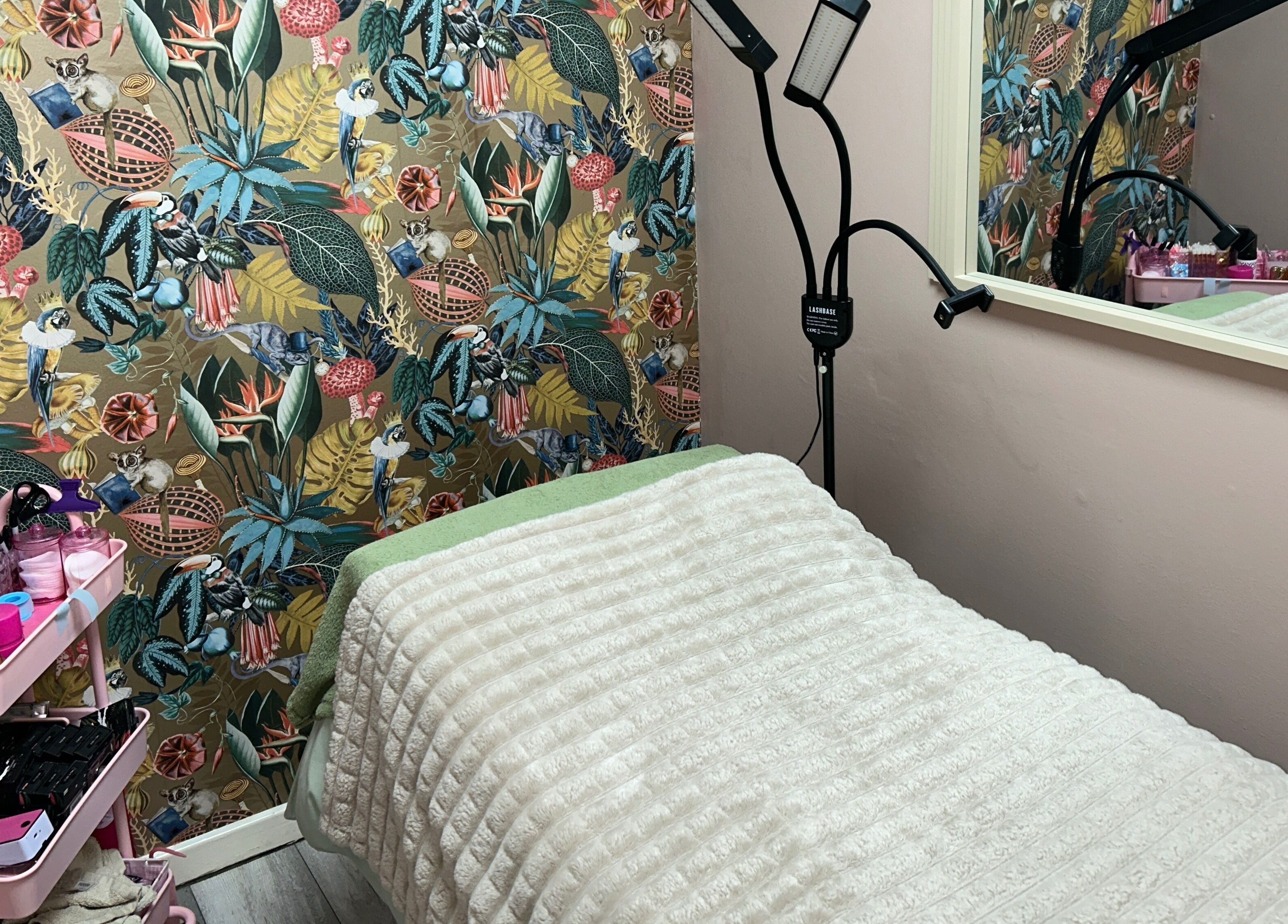 Cozy treatment area at Lashandblowbarx, Widnes, England with vibrant decor and a comfortable bed.