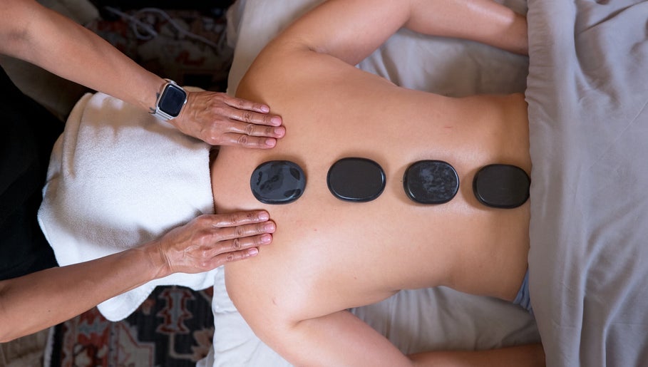 Hot stone massage therapy at The ZenSai Spa, Burbank, California, US, offering relaxation and wellness.