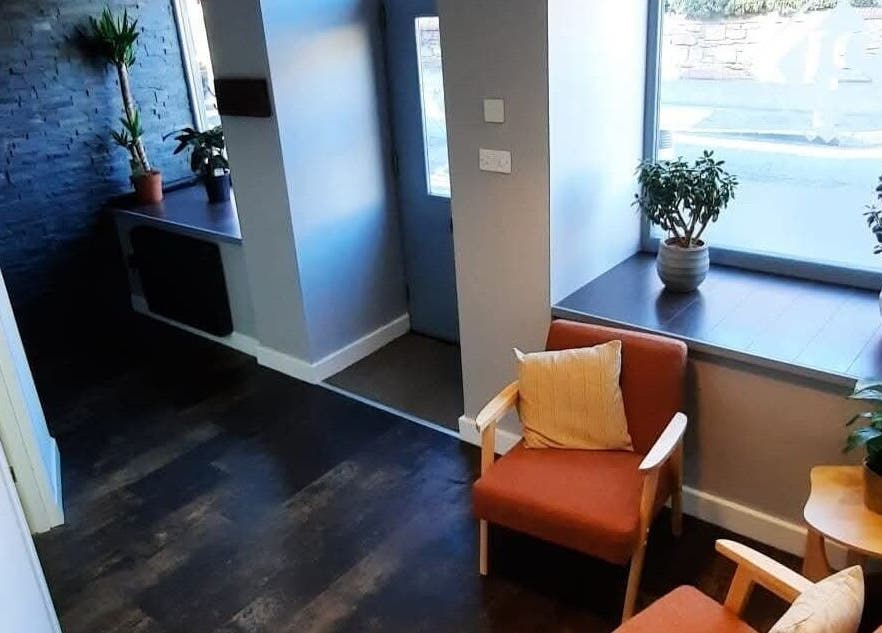 Inviting seating area in Peak Performance Soft Tissue Therapy, Kirriemuir, Scotland, GB with plants and natural light.