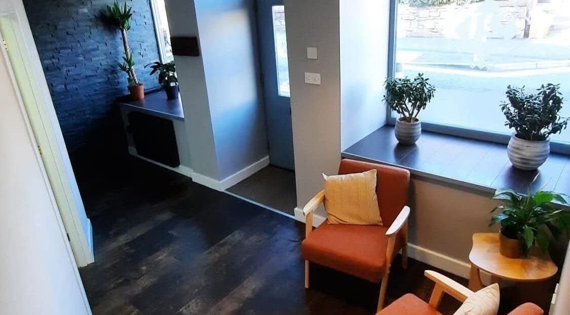 Inviting seating area in Peak Performance Soft Tissue Therapy, Kirriemuir, Scotland, GB with plants and natural light.