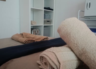 Relaxing massage table setup at HoVana Holistics & Beauty, Glasgow, Scotland, GB with neatly folded towels.