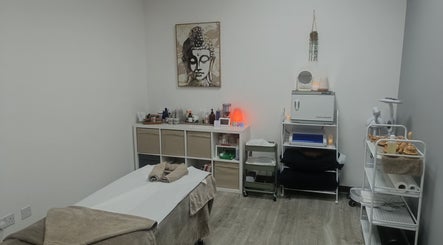 Relaxing treatment room at HoVana Holistics & Beauty, Glasgow, Scotland, GB featuring a massage table and calming decor.