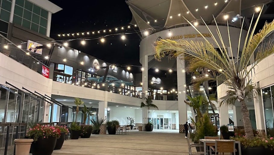 Outdoor courtyard near Men's Grooming Lounge By Mel, Mission Viejo, California, US, adorned with string lights.