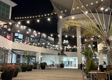 Outdoor courtyard near Men's Grooming Lounge By Mel, Mission Viejo, California, US, adorned with string lights.