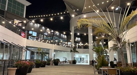 Outdoor courtyard near Men's Grooming Lounge By Mel, Mission Viejo, California, US, adorned with string lights.