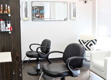 Stylish interior of Men's Grooming Lounge By Mel in Mission Viejo, California, US with modern salon chairs.