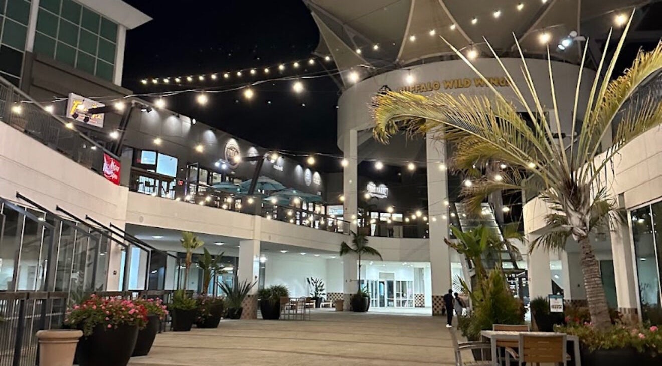 Night scene at Men's Grooming Lounge By Mel, Mission Viejo, California, US, showcasing modern architecture and lights.