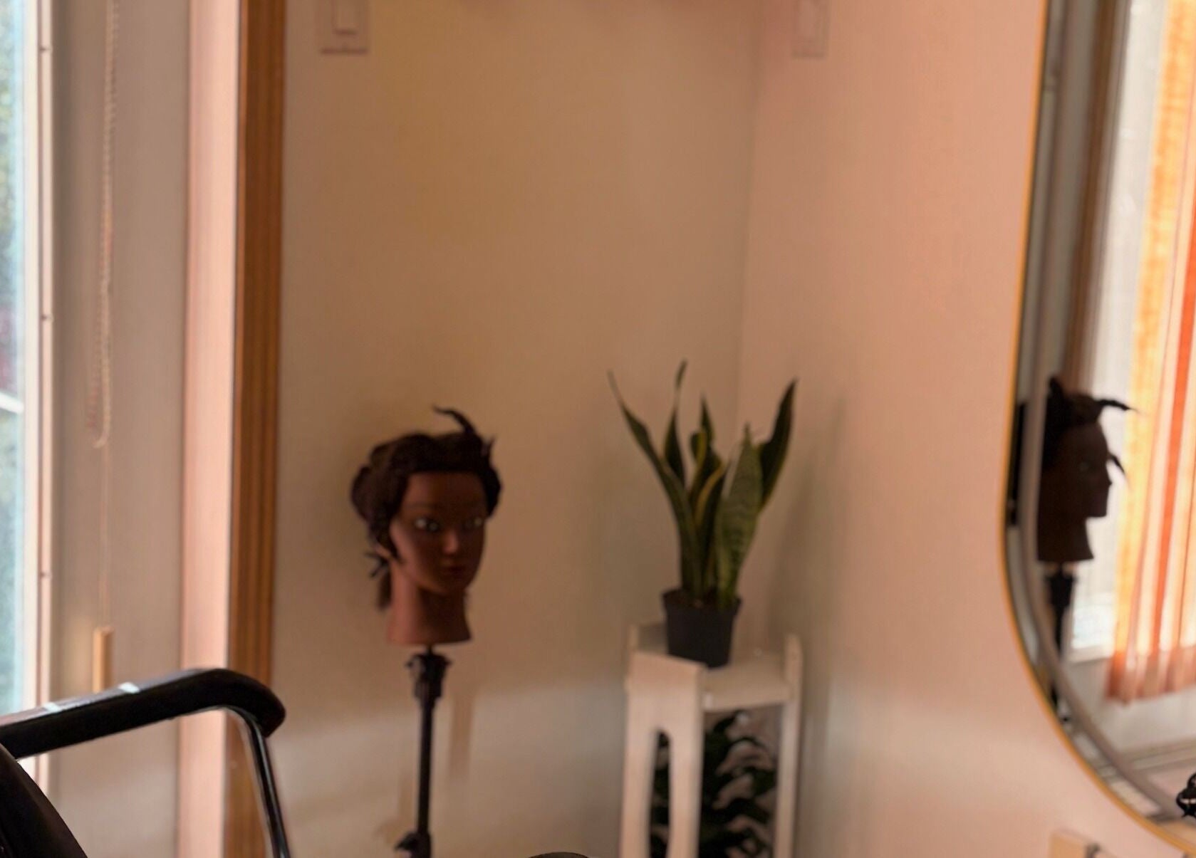 Interior of FADIV salon de coiffure in Laval, Québec, CA, featuring a mannequin head and mirror.