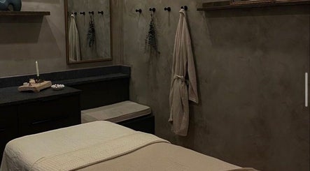 Cozy massage room at STUDIO LEME DUBAI, Dubai, AE, featuring soothing decor and dim lighting for relaxation.