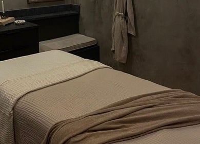 Calm spa room at STUDIO LEME DUBAI, Dubai, Dubai, AE, featuring a massage table with beige linens.