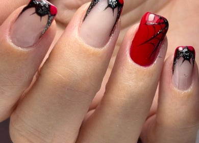 Intricate spider nail art design at NailVow, Willemstad, Curaçao, CW. Red and black themed manicure.