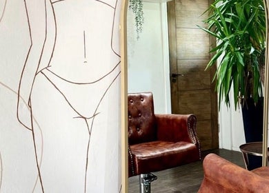 Elegant lounge at Styled by Beth, Bromsgrove, England, GB, featuring a leather chair and artistic walls.