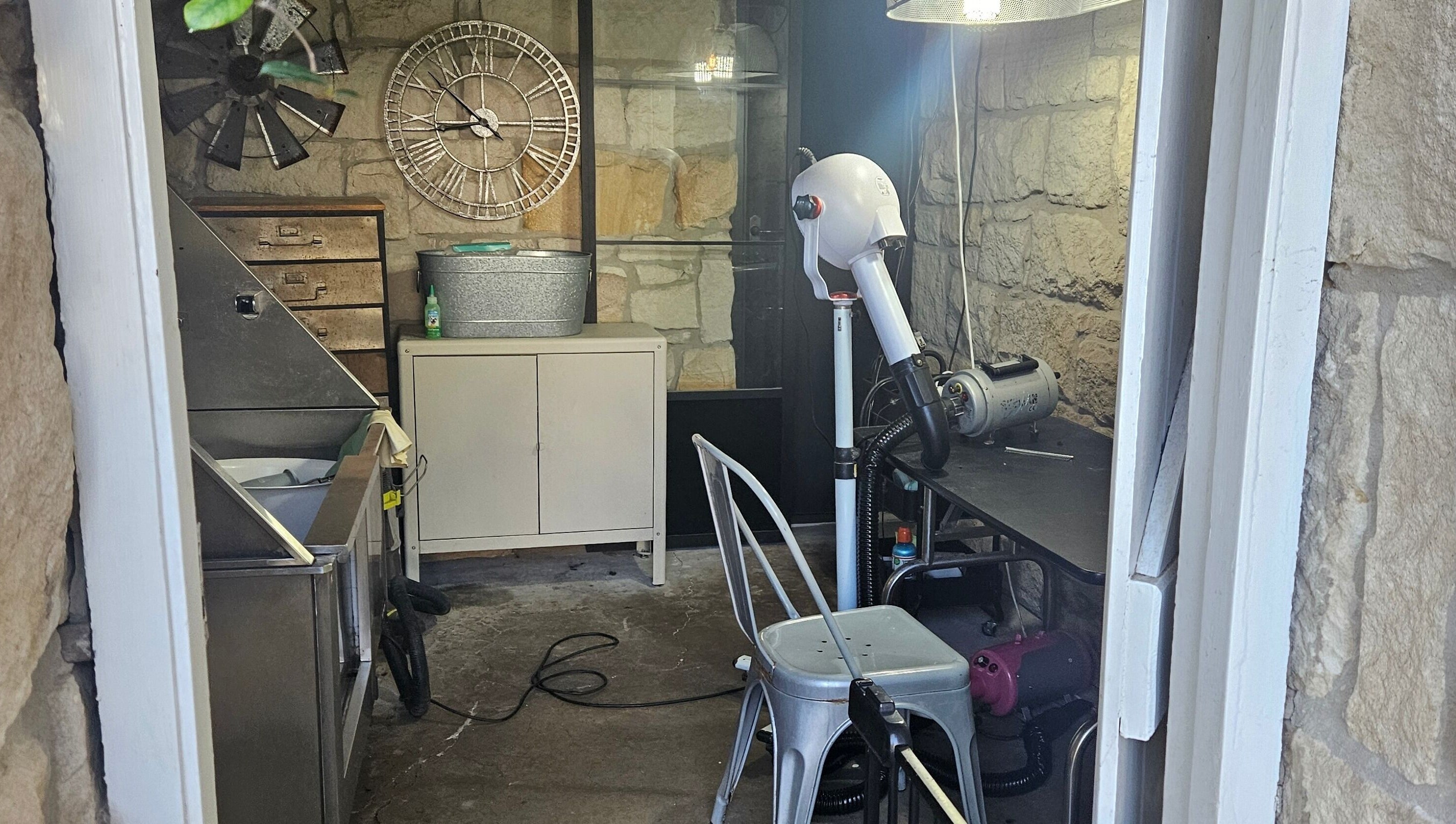 Interior of Killara Pups grooming area with rustic stone walls in Killara, New South Wales, AU.
