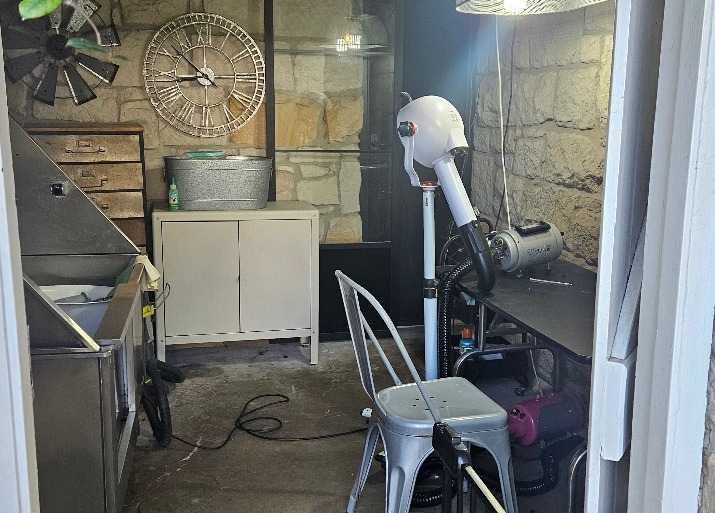Interior of Killara Pups grooming area with rustic stone walls in Killara, New South Wales, AU.