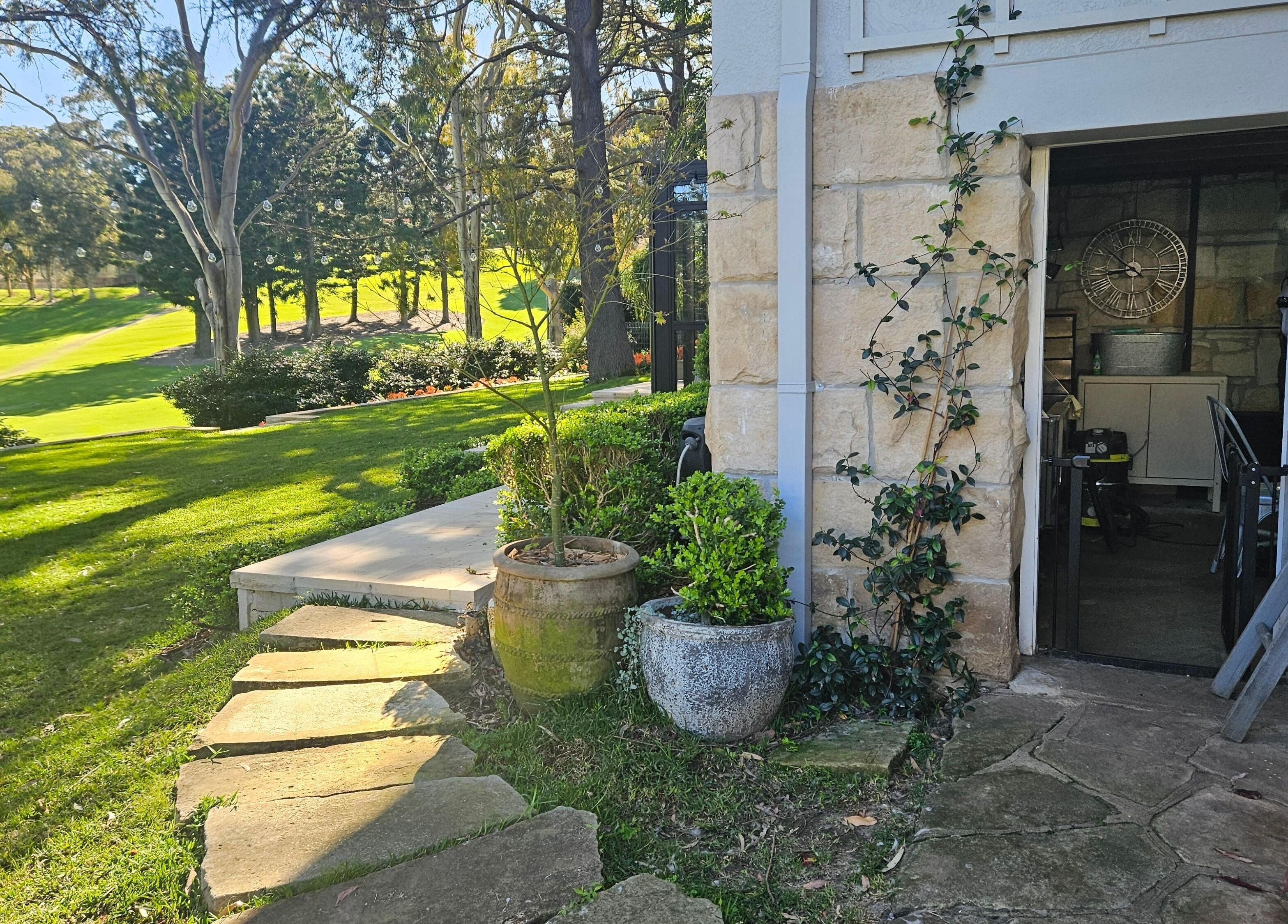 Stone path and lush garden at Killara Pups, Killara, New South Wales, AU