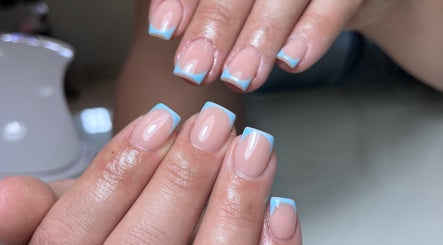 Manicured hands with blue-tipped nails at Bellezza Nail & Hair Lab, Springs, Gauteng, ZA.