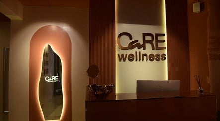 Care Wellness Bangalore lobby with warm lighting in Bengaluru, Karnataka, IN. Elegant design illuminates welcome space.