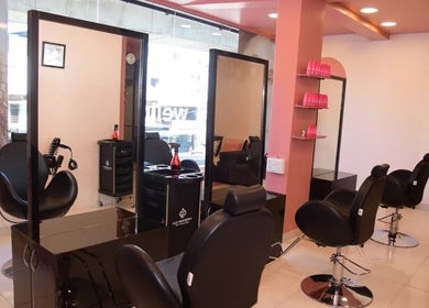 Modern salon interior at Care Wellness Bangalore, Bengaluru, Karnataka, IN showcasing stylish black chairs and mirrors.