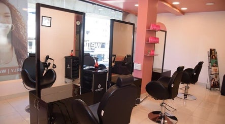 Modern salon interior at Care Wellness Bangalore, Bengaluru, Karnataka, IN showcasing stylish black chairs and mirrors.