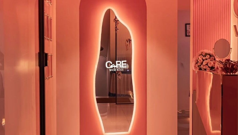 Ambient hallway at Care Wellness Bangalore with glowing mirror, located in Bengaluru, Karnataka, IN.