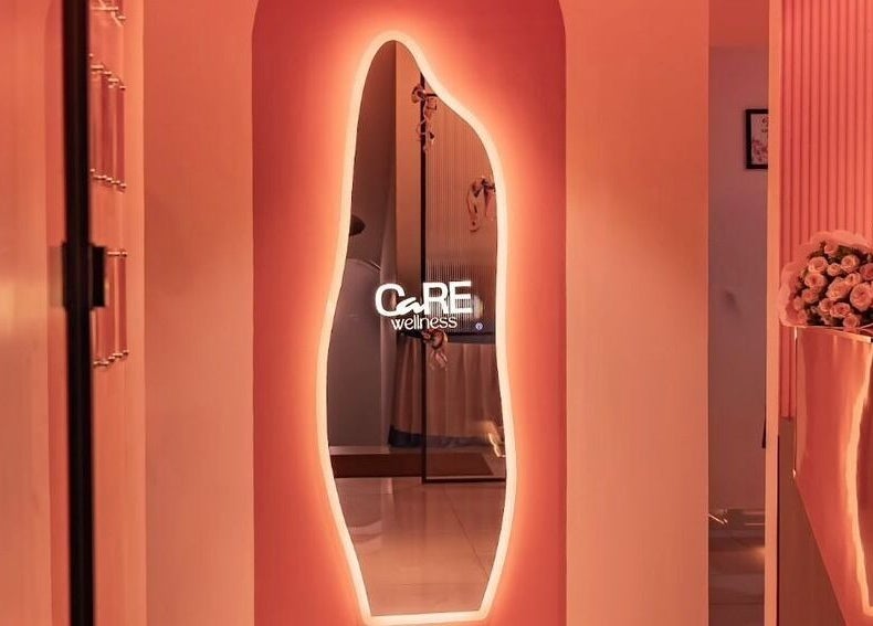 Ambient hallway at Care Wellness Bangalore with glowing mirror, located in Bengaluru, Karnataka, IN.